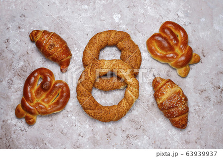 Various sweet buns on brown concrete background,top view Various sweet buns on brown concrete background,top view 63939937