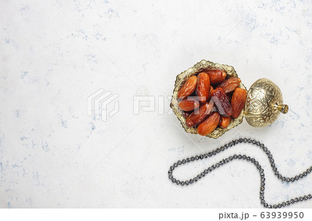 Beautiful bowl full of date fruits symbolizing Ramadan,top view 63939950