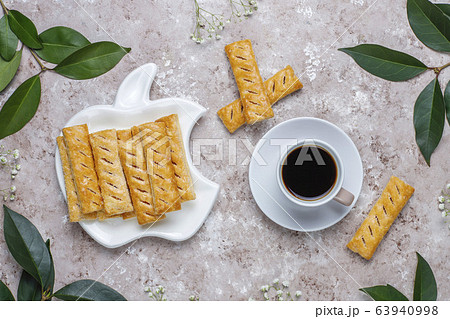 Apple puff pastry cookies in apple shape plate with fresh apples ,top view Apple puff pastry cookies in apple shape plate with fresh apples ,top view 63940998