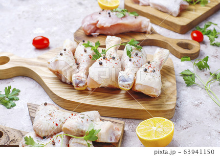 Raw chicken meat fillet, thigh, wings and legs with herbs ,spices,lemon and garlic. Top view 63941150