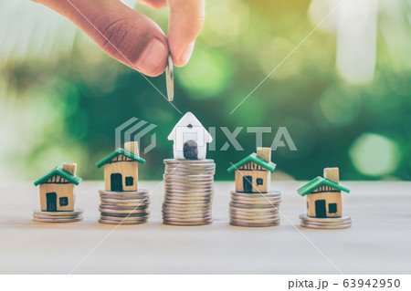 House placed on coins. hand that is coin down the house. Indicates the growth of home and finance. planning savings money of coins to buy a home concept property mortgage and investment for a house. House placed on coins. hand that is coin down the house. Indicates the growth of home and finance. planning savings money of coins to buy a home concept property mortgage and investment for a house. 63942950