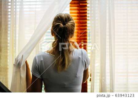 Woman stand alone at home for protection corona-2019 virus. 63943123
