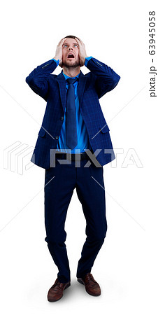 Young desperate man with hands on head clasped. 63945058