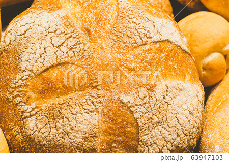 Fresh baked bread with a golden crust, loaf, buns, white, rye on a rustic wooden background with sil rustic. Flat layout 63947103