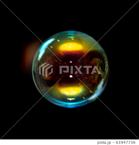 Multicolored soap bubble isolated on a black Multicolored soap bubble isolated on a black 63947736
