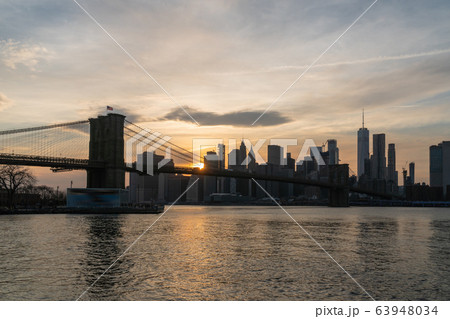 scene of New york Cityscape with Brooklyn Bridge over the east river at the sunset time, USA downtown skyline, Architecture and transportation concept 63948034
