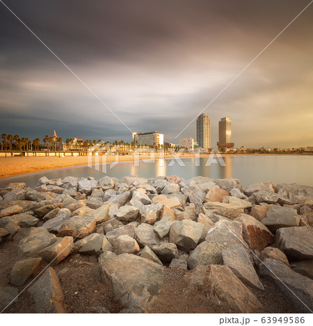 Dramatic sunrset on beach of Barcelona with palm 63949586