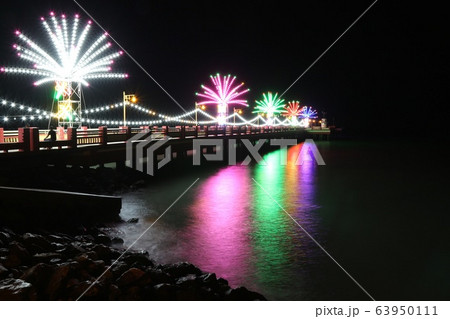 Colorful lights on the bridge Reflected into the sea surface smooth Caused by a slow shutter speed Colorful lights on the bridge Reflected into the sea surface smooth Caused by a slow shutter speed 63950111