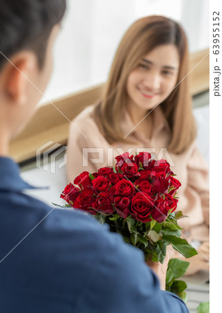 Man hiding flower at back. 63955152
