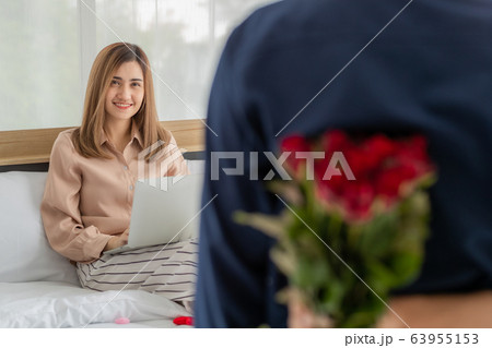 Man hiding flower at back. 63955153