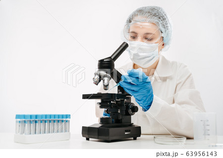 female scientist working with powerful microscope and reagent in clinic female scientist working with powerful microscope and reagent in clinic 63956143