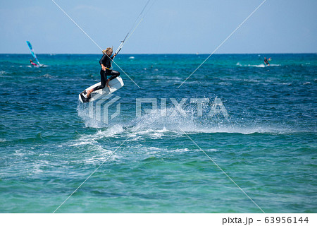 The kite surfer rides the waves of the Atlantic Ocean The kite surfer rides the waves of the Atlantic Ocean 63956144