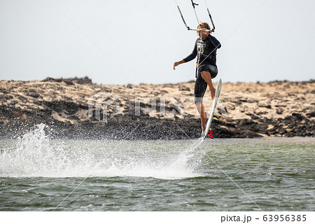 The kite surfer rides the waves of the Atlantic Ocean The kite surfer rides the waves of the Atlantic Ocean 63956385