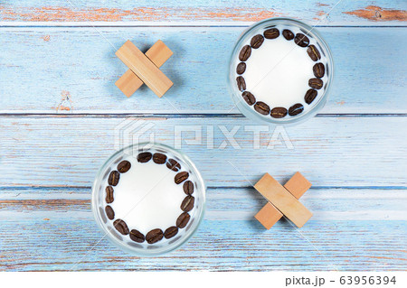 Noughts and crosses from glasses with milk and wooden blocks Noughts and crosses from glasses with milk and wooden blocks 63956394