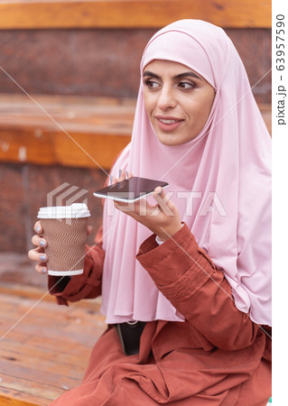 Woman recording voice message for friend stock photo Woman recording voice message for friend stock photo 63957590