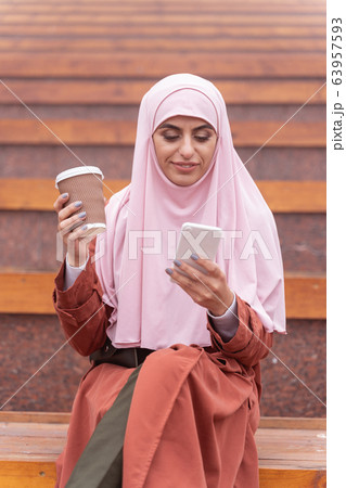 Chatting online and drinking coffee stock photo Chatting online and drinking coffee stock photo 63957593