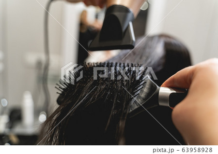 Focused photo on hairdryer that being in hand 63958928