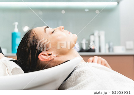 Profile of young woman that washing hair Profile of young woman that washing hair 63958951