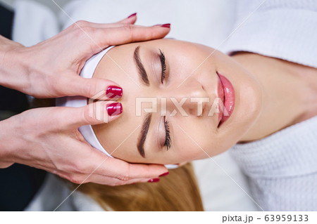 Beautiful smiling woman at cosmetologist stock photo Beautiful smiling woman at cosmetologist stock photo 63959133
