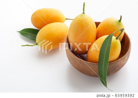 Marian plum, plum mango in wooden bowl 63959392