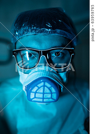 Young male researcher carrying out scientific experiment. Young male researcher carrying out scientific experiment. 63959765
