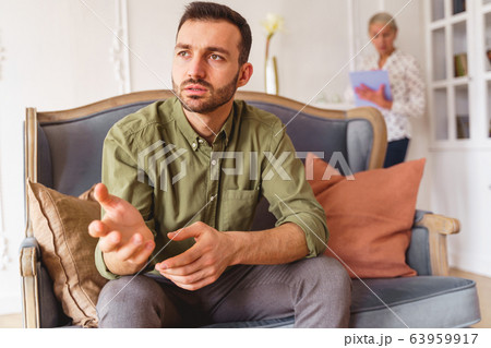 Sad male patient staring into the distance 63959917