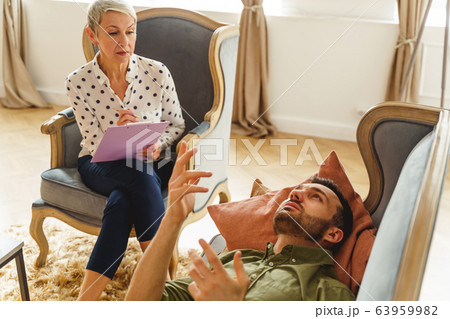 Patient discussing his psychological problems with a psychotherapist 63959982