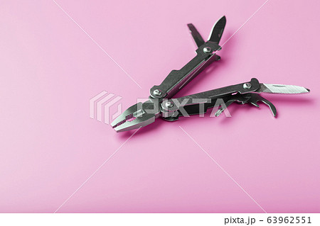 Multitool is a multi-functional tool on a pink 63962551