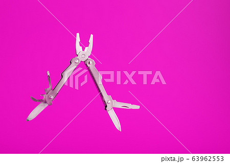 Multitool is a multi-functional tool on a pink 63962553
