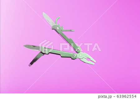 Multitool is a multi-functional tool on a pink Multitool is a multi-functional tool on a pink 63962554