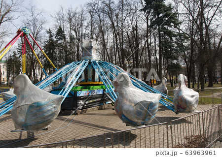 Carousels closed due coronavirus COVID-19 quarantine in the city park with nobody, all people at home Carousels closed due coronavirus COVID-19 quarantine in the city park with nobody, all people at home 63963961
