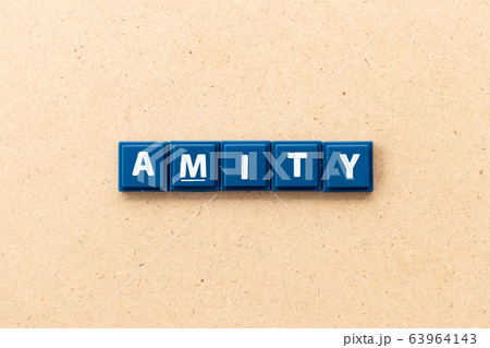 Tile letter in word amity on wood background Tile letter in word amity on wood background 63964143