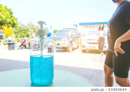 Antiseptic hand gel or alcohol gel prevent the spread of germs and bacteria and avoid infections corona virus,covid-19 prevention for serving customers in the gas station. 63964644