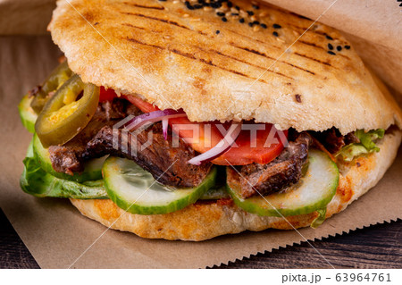 Beef pieces fried on trochanter with parsley and dill with pickles in a tortilla cooked in tandem 63964761