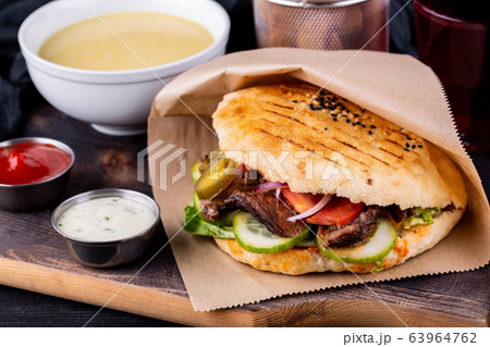 Dener with beef in the cake, served with cream sauce, ketchup, puree soup, roasted potatoes and a glass of compote 63964762