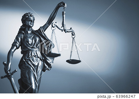 Figure of Justice holding scales and a sword 63966247