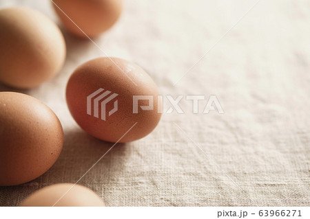Loose fresh brown hens eggs on textile Loose fresh brown hens eggs on textile 63966271