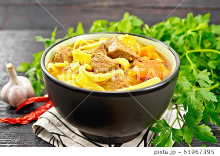 Lagman in bowl on dark wooden board Lagman in bowl on dark wooden board 63967395