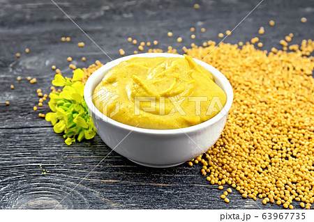 Sauce mustard in bowl with seeds and flower Sauce mustard in bowl with seeds and flower 63967735