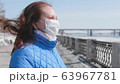 A girl in a protective mask on the street. Prevention and protection of health and safety of life. Coronavirus N1H1, covid-19, pandemic in the world. 63967781