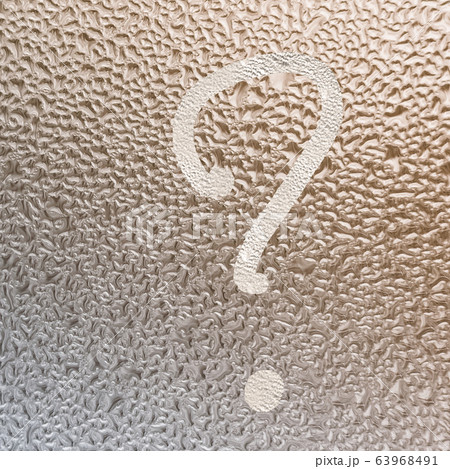 question mark on the misted glass with water drops 63968491