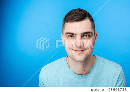 A young man in blue t-shirt smiles, picture A young man in blue t-shirt smiles, picture 63968738