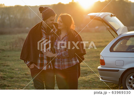 Beautiful couple spend time on a sunset park Beautiful couple spend time on a sunset park 63969330