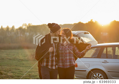 Beautiful couple spend time on a sunset park Beautiful couple spend time on a sunset park 63969333
