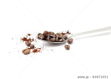 Spoon with coffee beans isolated on white Spoon with coffee beans isolated on white 63971051