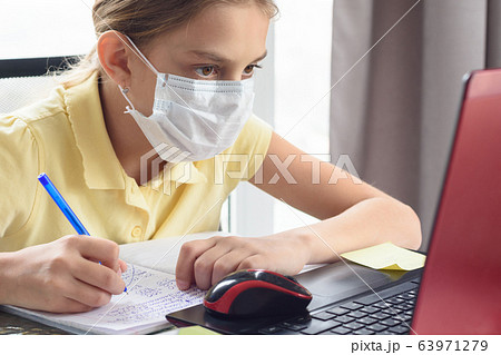Girl in a protective mask remotely watch training 63971279
