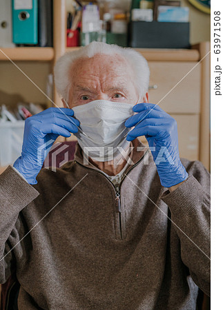 Old man wearing protective mask and gloves 63971508
