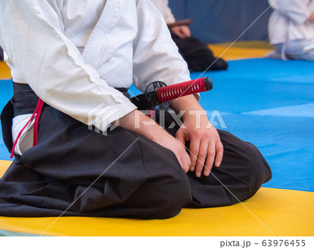 Man sitting on the tatami with japanese sword Man sitting on the tatami with japanese sword 63976455