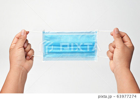 hand holding antiviral medical mask protection 63977274