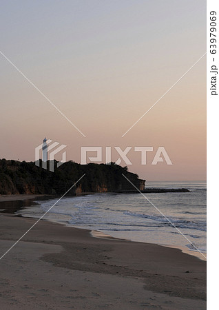 朝焼けの灯台の見える砂浜の風景 朝焼けの灯台の見える砂浜の風景 63979069